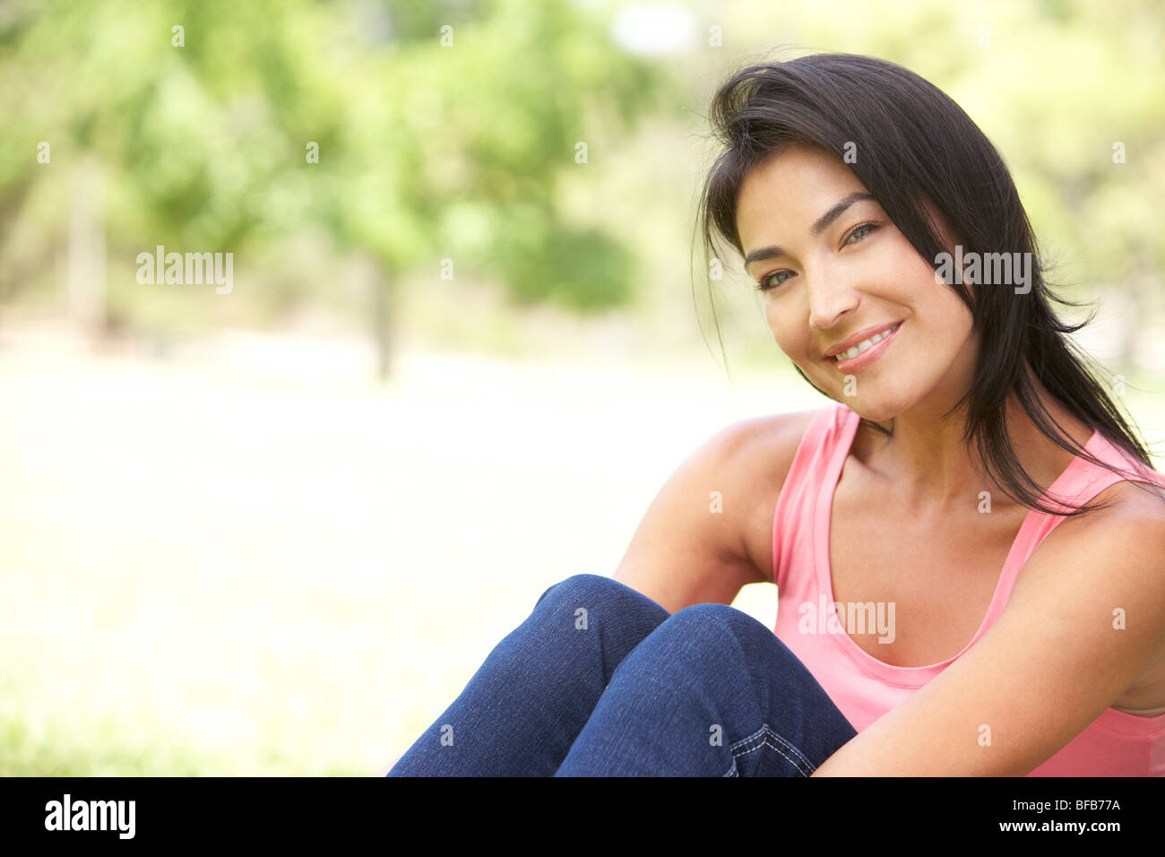 Portrait Of Young Woman In Park Stock Photo - Alamy