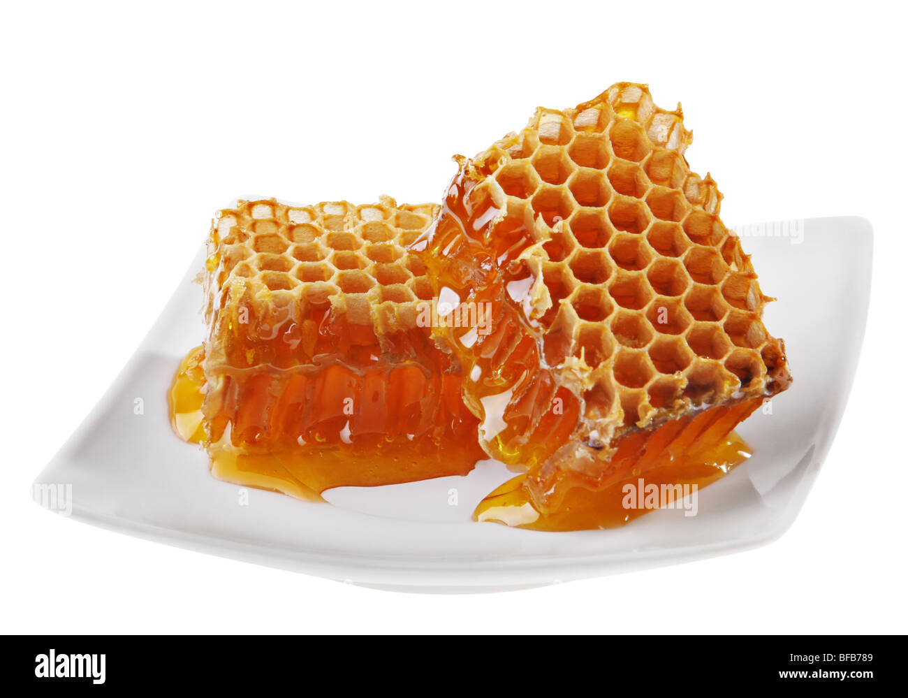 Yellow honeycomb wax cell detail slice on white plate Stock Photo