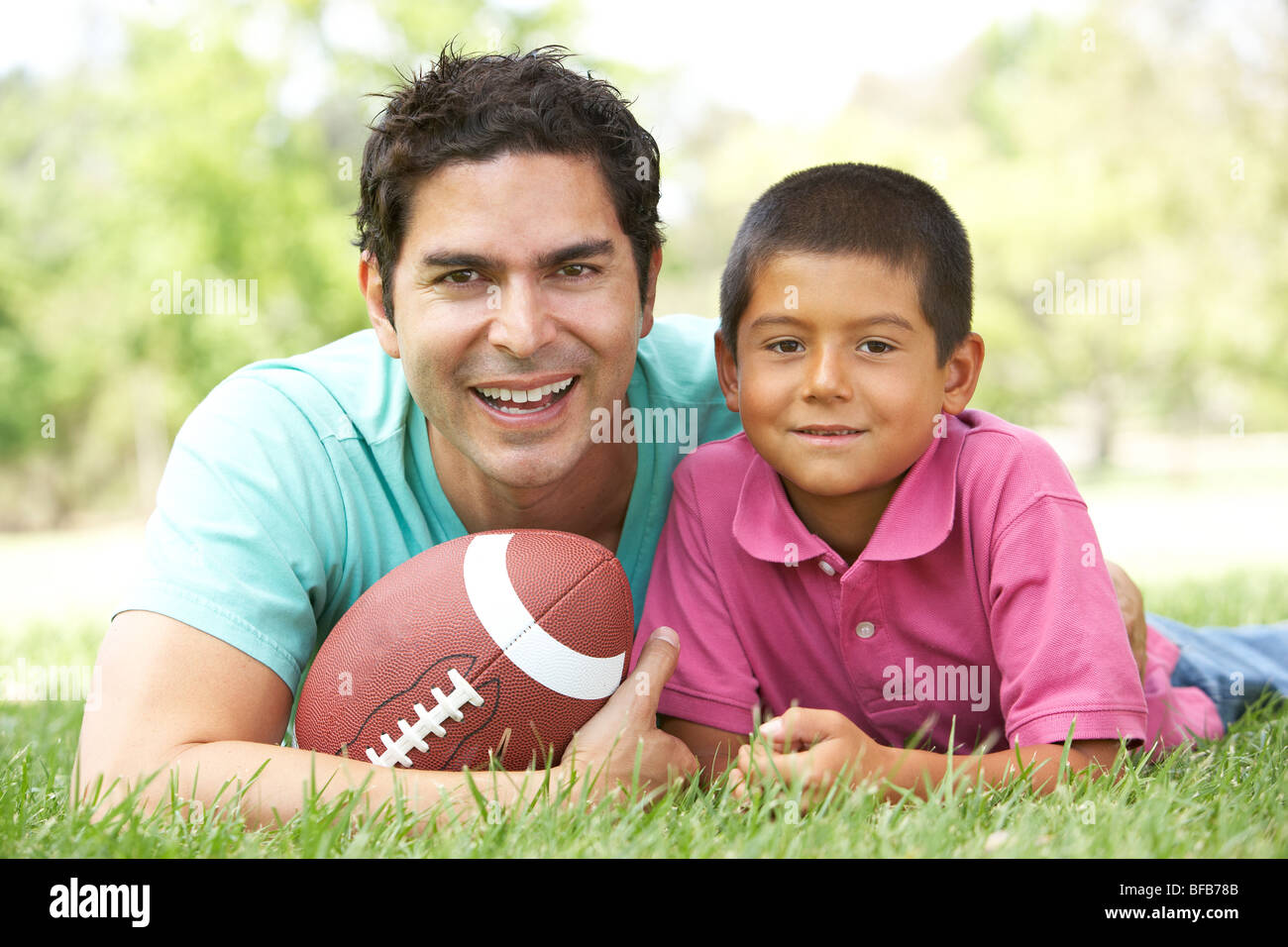 Father And Son In Park With American Football Stock Photo - Alamy
