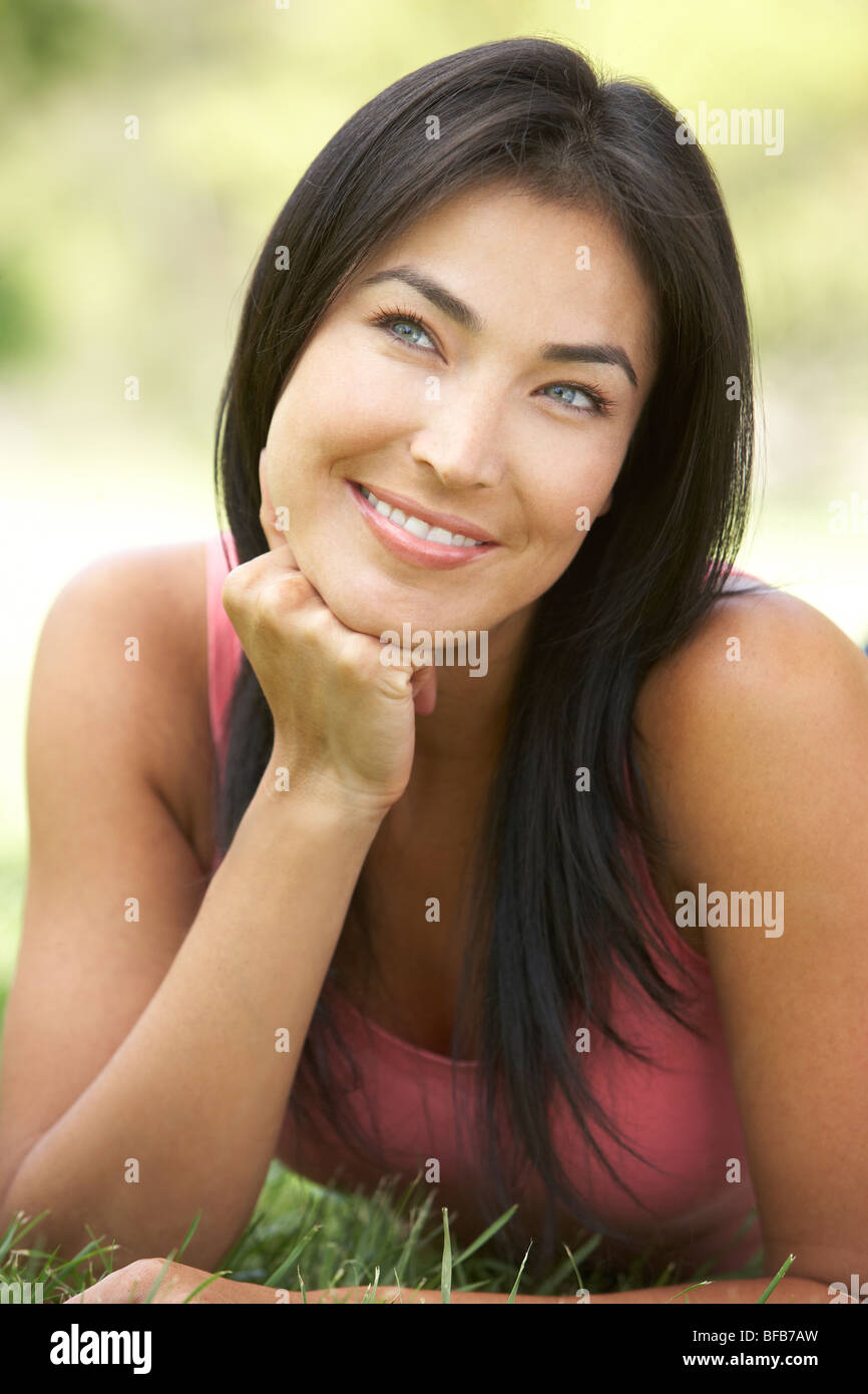 Portrait Of Young Woman In Park Stock Photo - Alamy