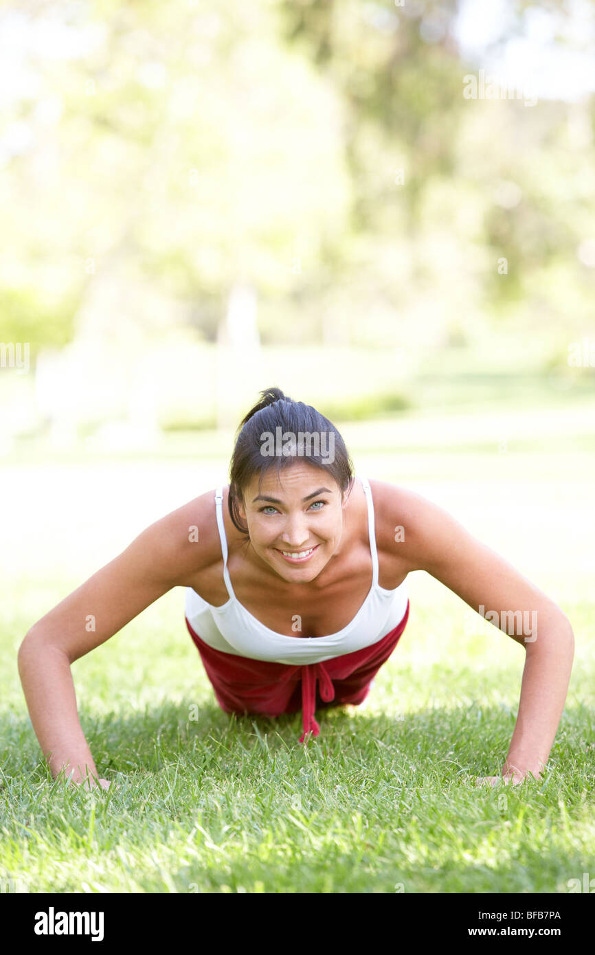 Young Woman Exercising In Park Stock Photo - Alamy