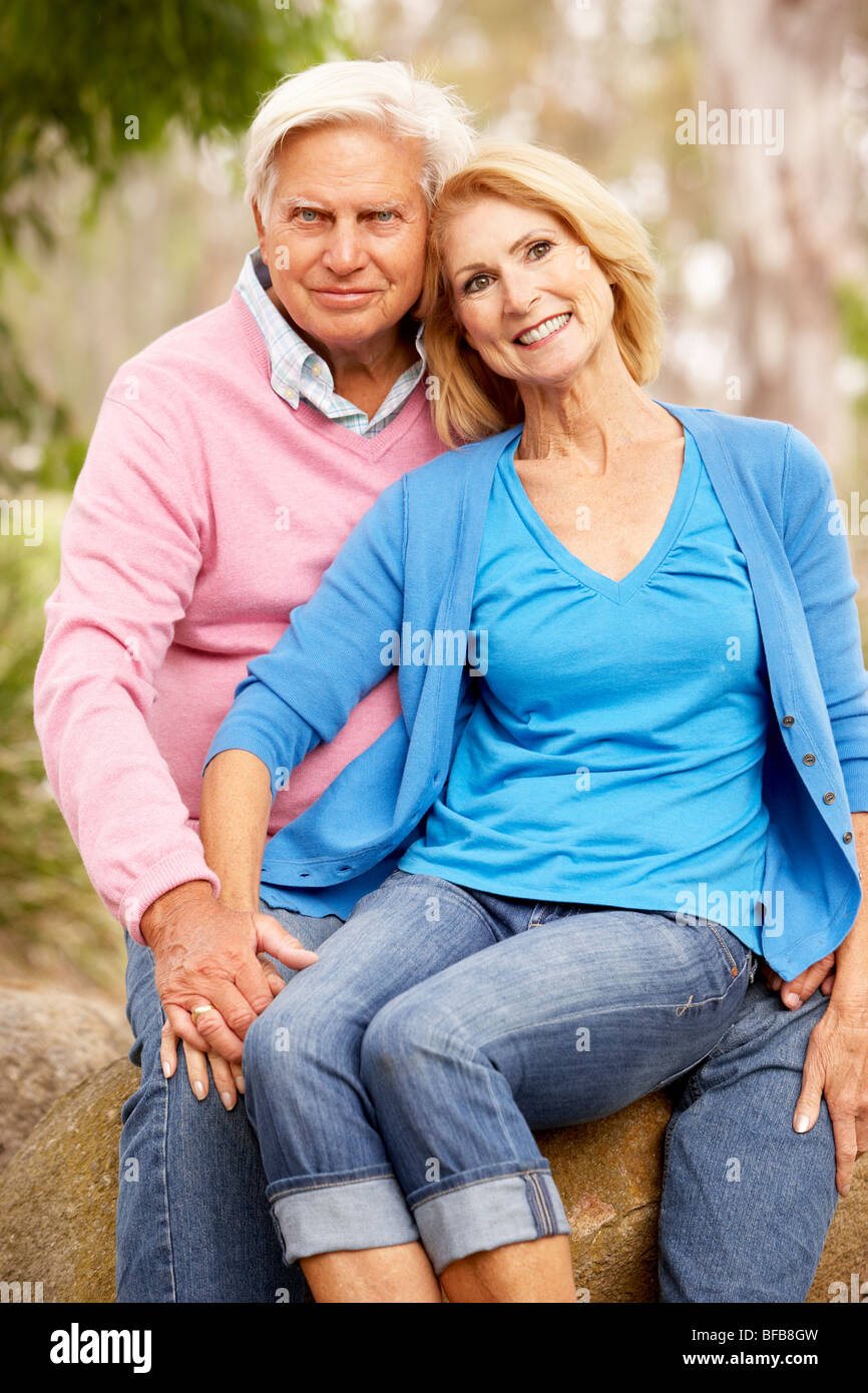 Senior Couple Sitting On Wall Stock Photo