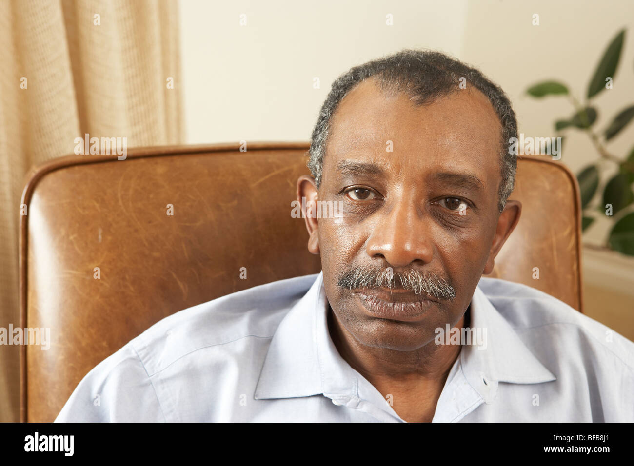 Senior man relaxing in chair at home hi-res stock photography and ...