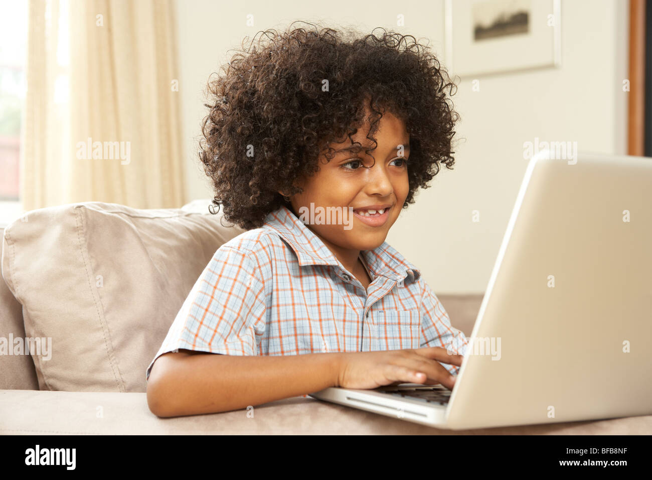 Young Boy Using Laptop At Home Stock Photo - Alamy