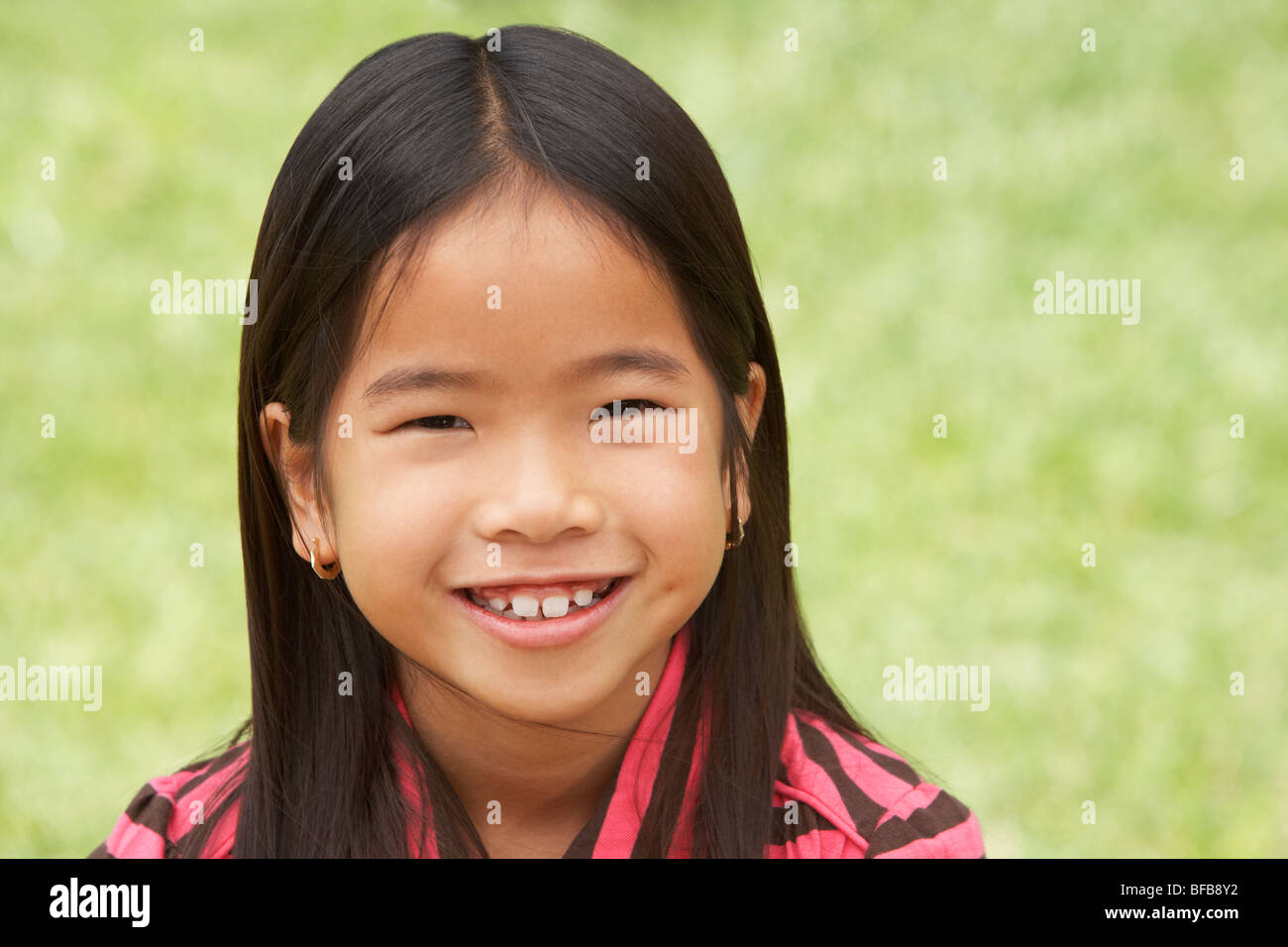 Portait Of Smiling Young Girl Outdoors Stock Photo