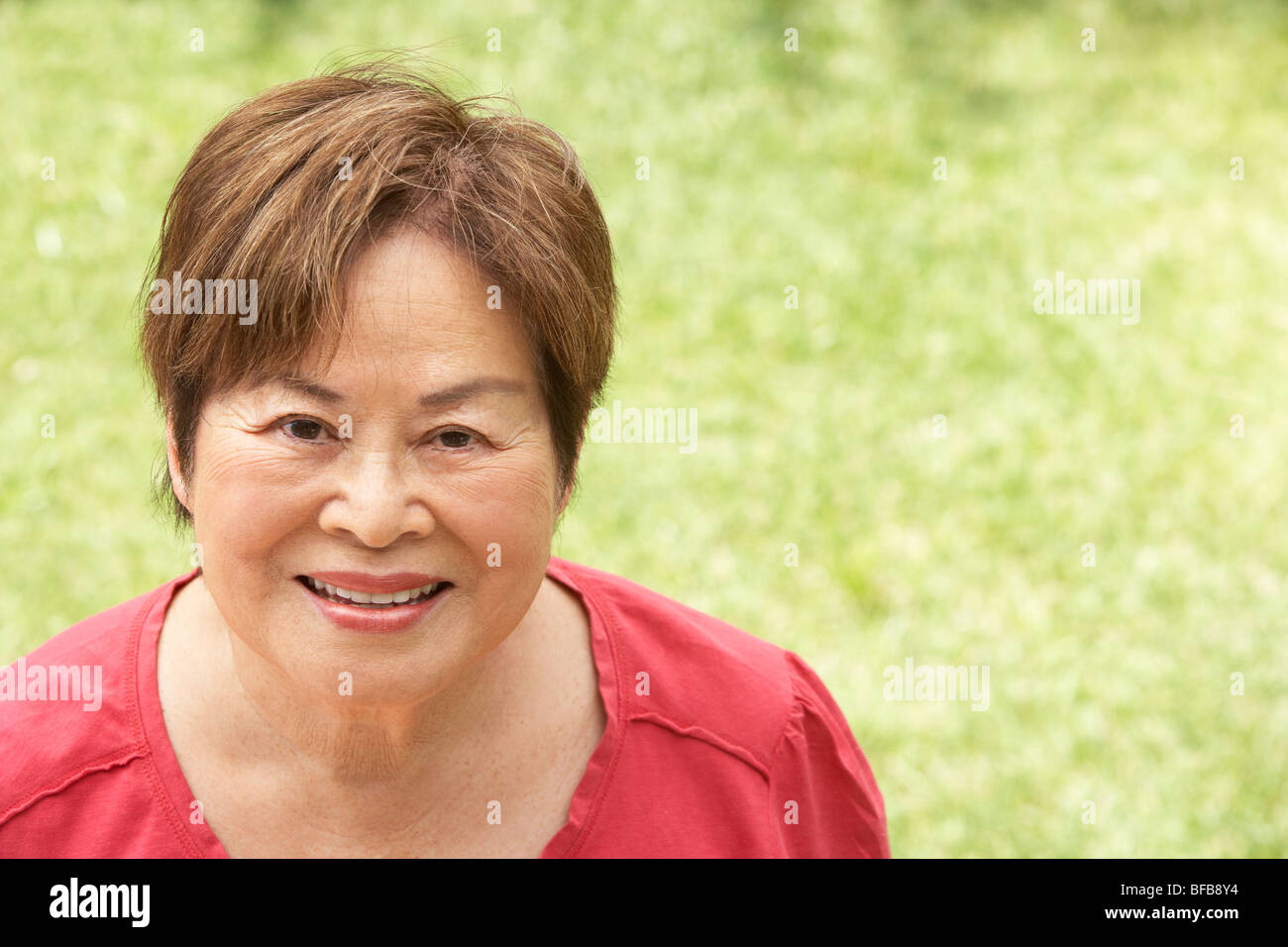 Portrait Of Smiling Senior Woman Outdoors Stock Photo