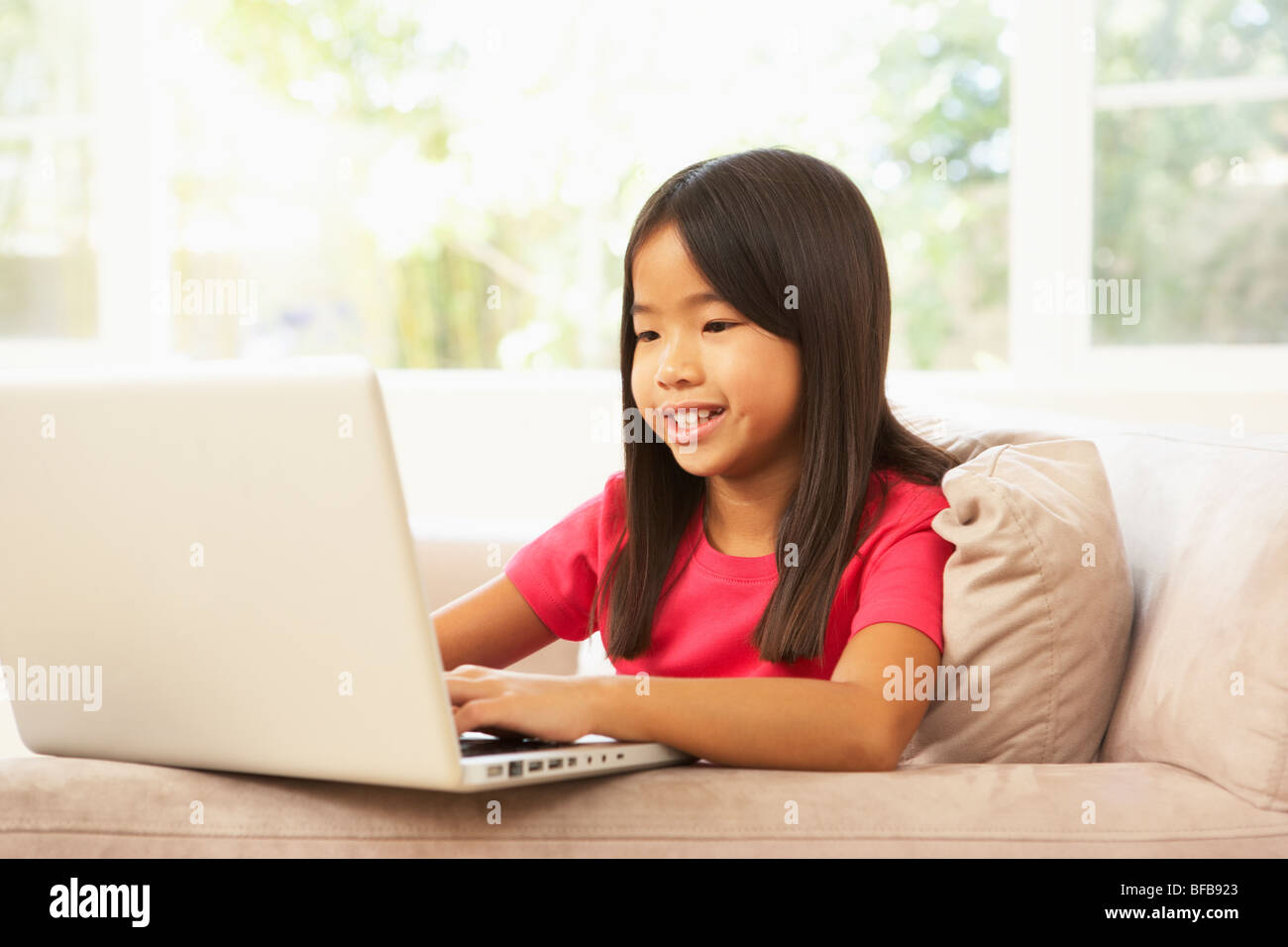 Young Girl Using Laptop At Home Stock Photo - Alamy