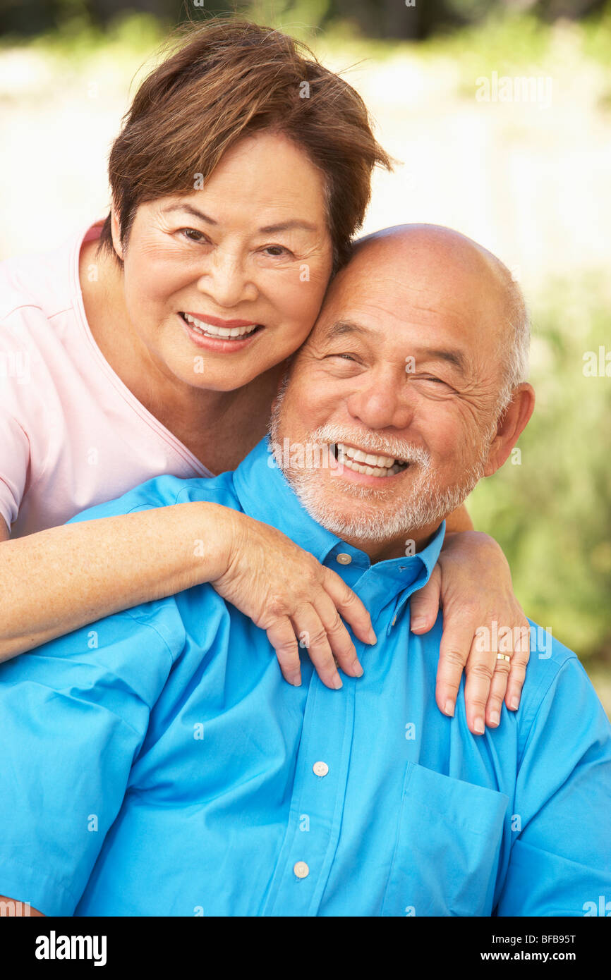 Senior Couple Relaxing In Garden Together Stock Photo - Alamy