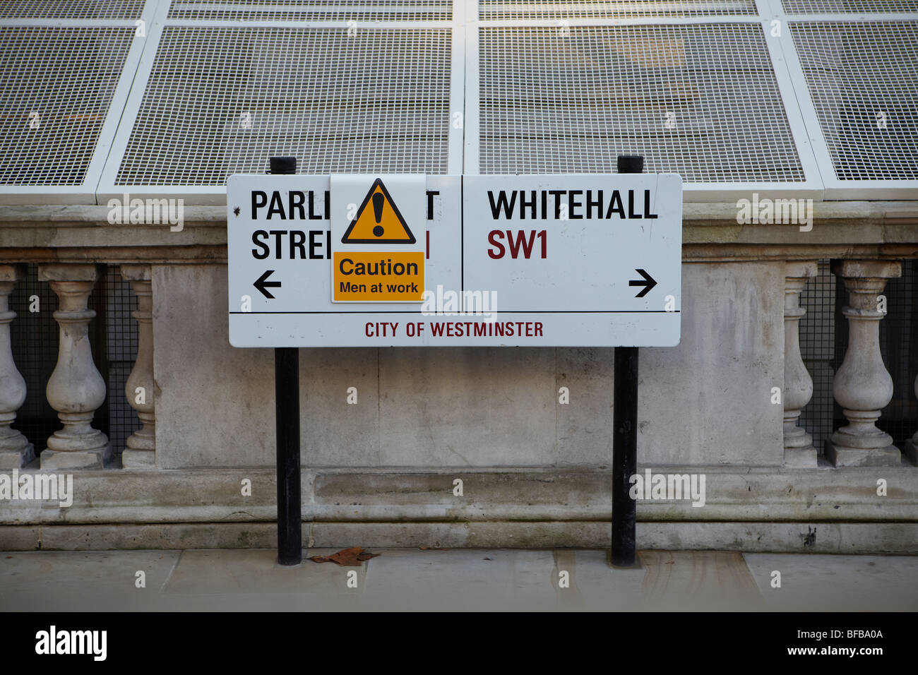 Parliament Street sign on Whitehall with a Caution Men at Work sticker. Stock Photo