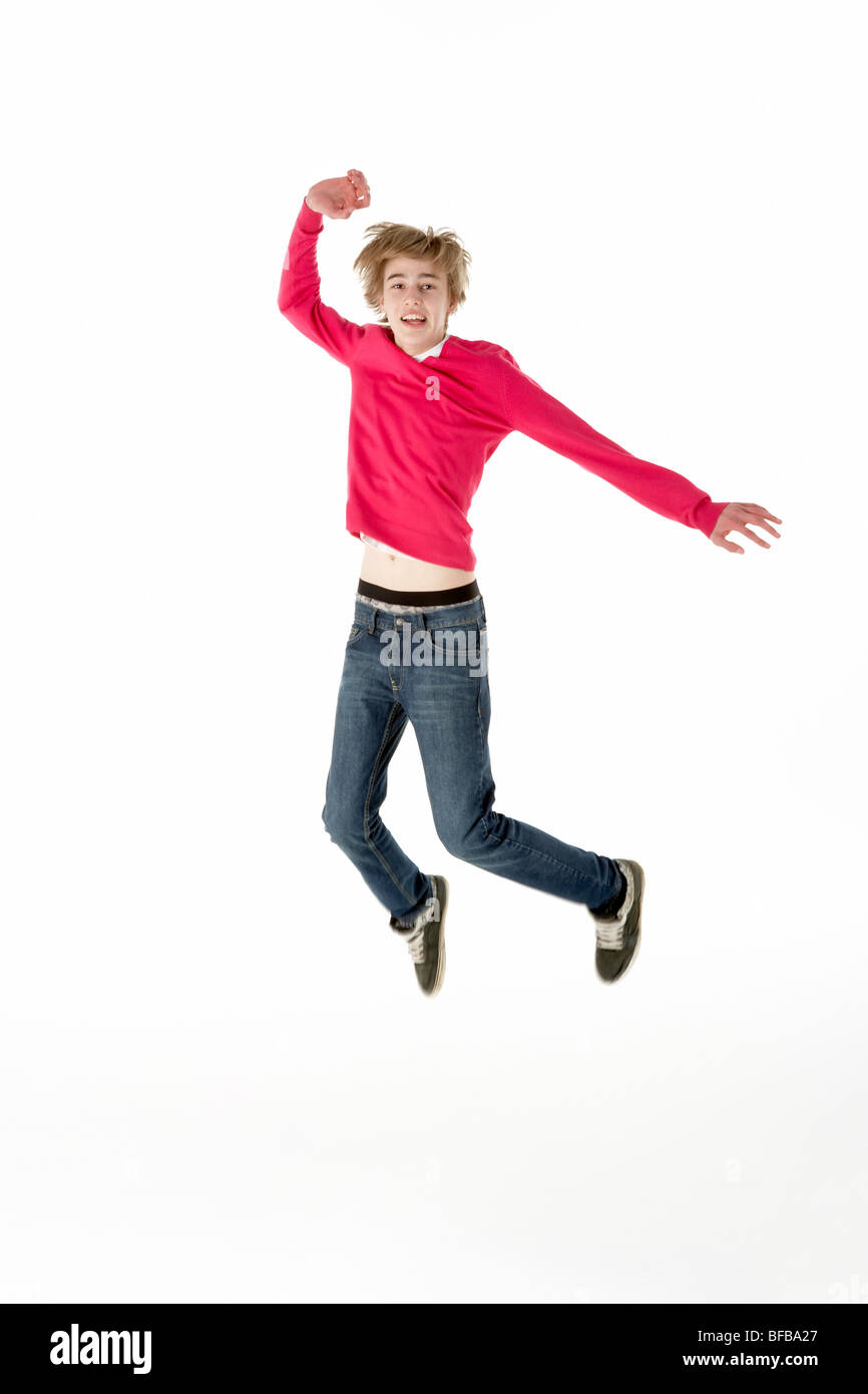 Full Length Studio Portrait Of Jumping Teenage Boy Stock Photo