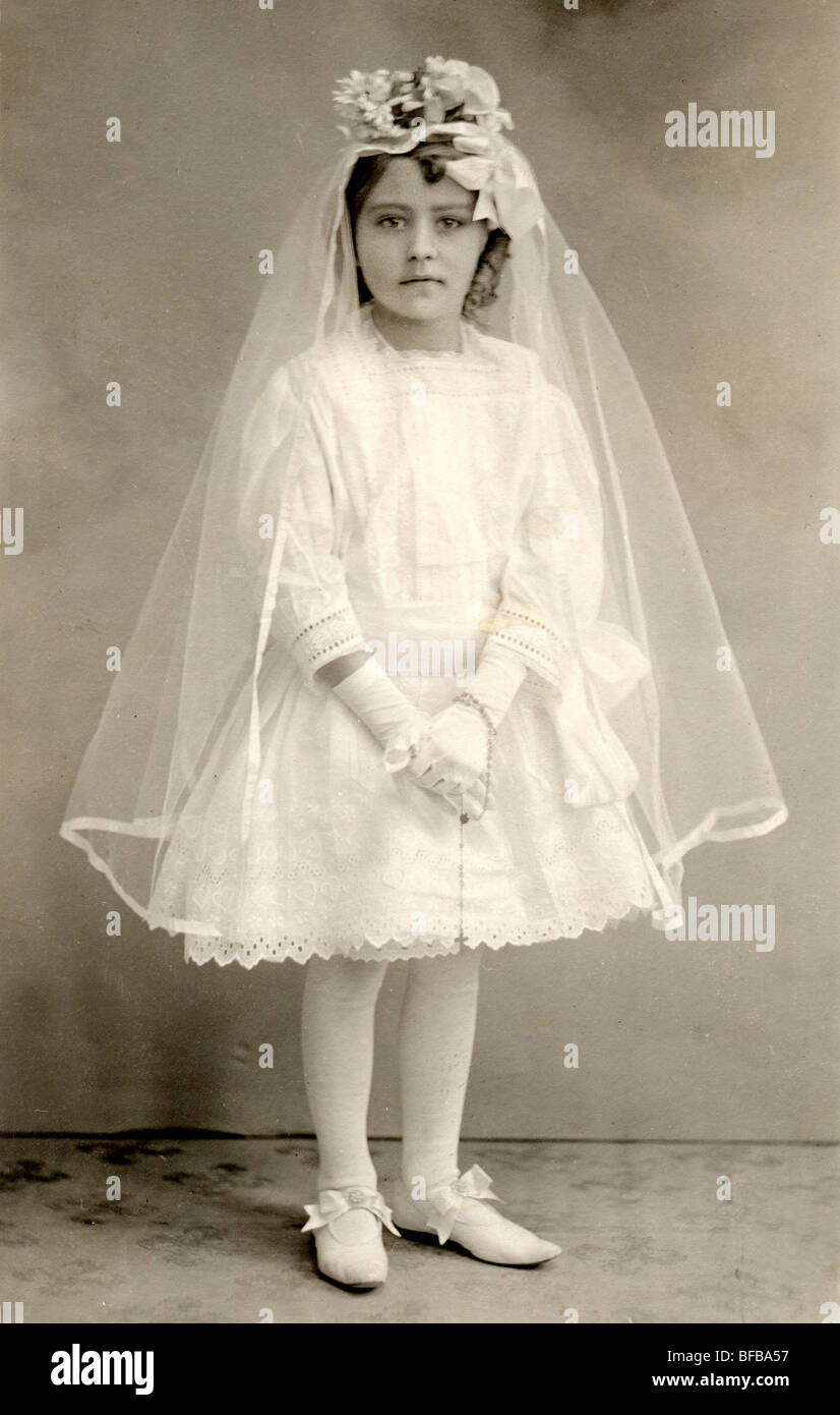 Serious Little Girl in First Communion Ensemble Stock Photo