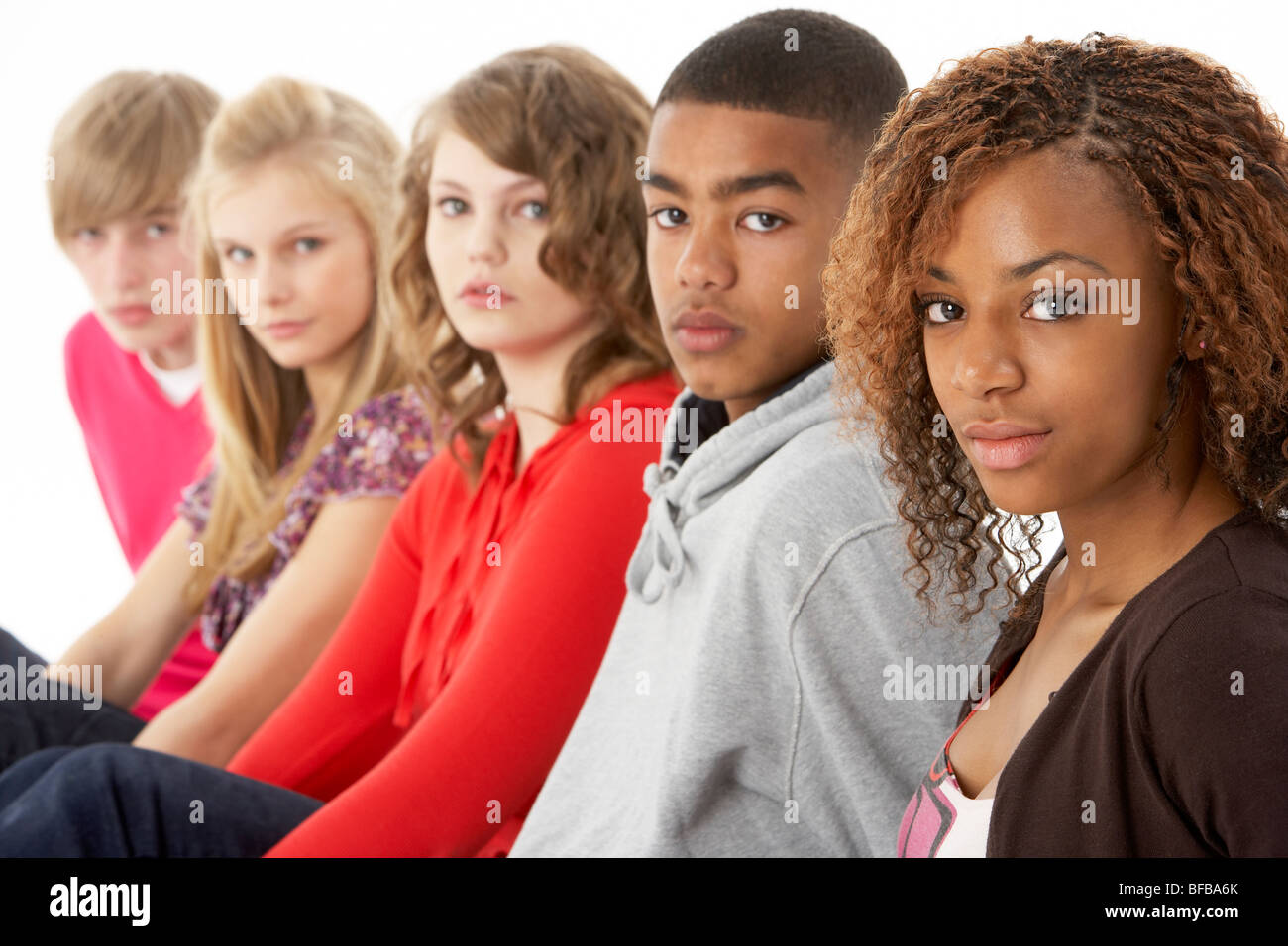 Studio Portrait Of Five Teenage Friends Standing In Line Stock Photo