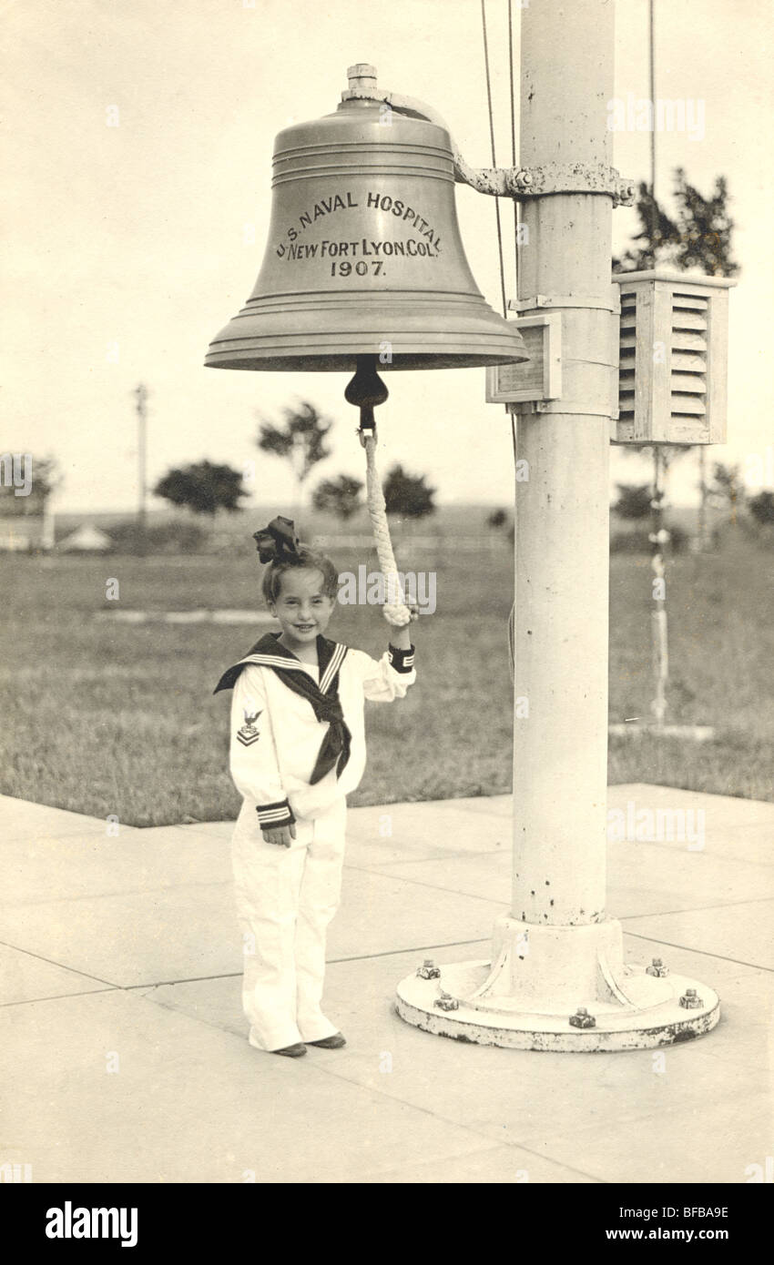 Girl in Sailor Suit Ringing Bell at U.S. Naval Hospital Stock Photo