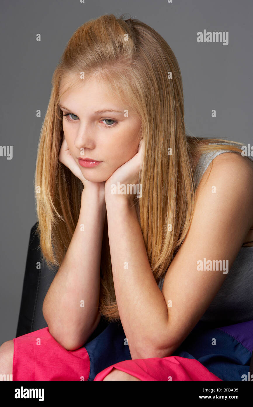 Studio Portrait Of Unhappy Teenage Girl Stock Photo