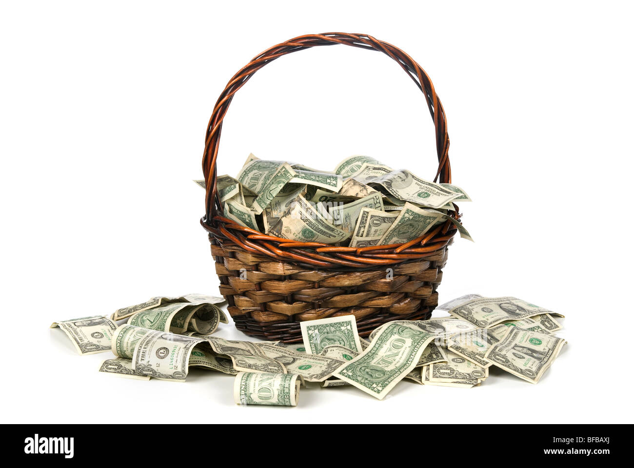 A wicker basket with handle holds a pile of cash. Good for most financial inferences Stock Photo