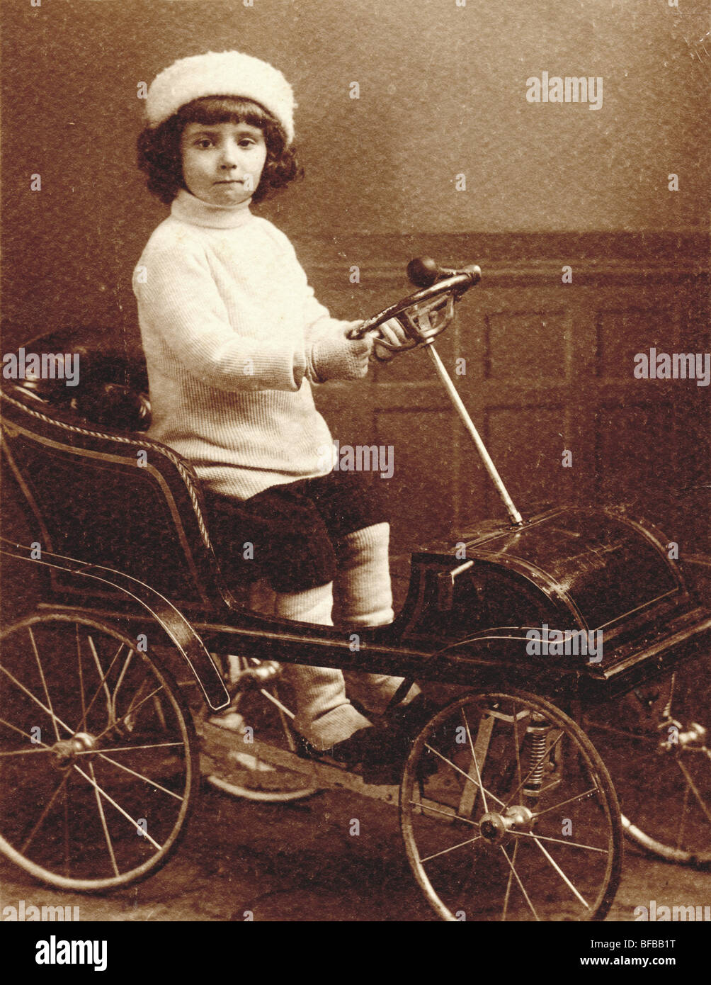 Little Girl Driving High Pedal Car Stock Photo