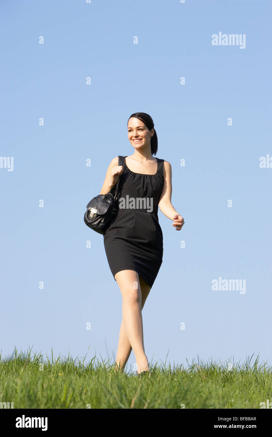 Woman Walking Through Summer Countryside Stock Photo