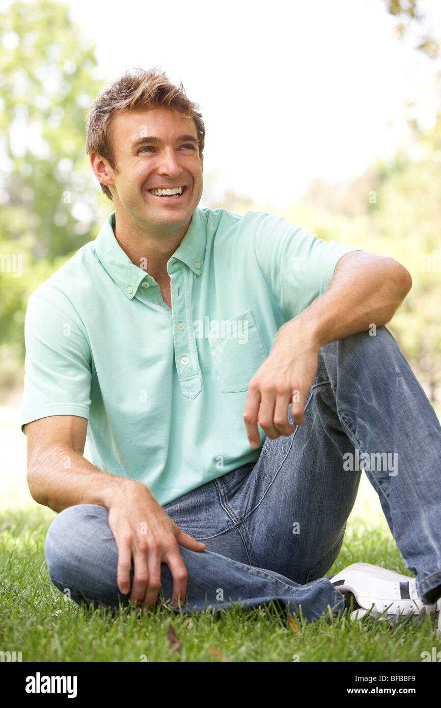 Relaxed smiling young man sitting hi-res stock photography and images ...