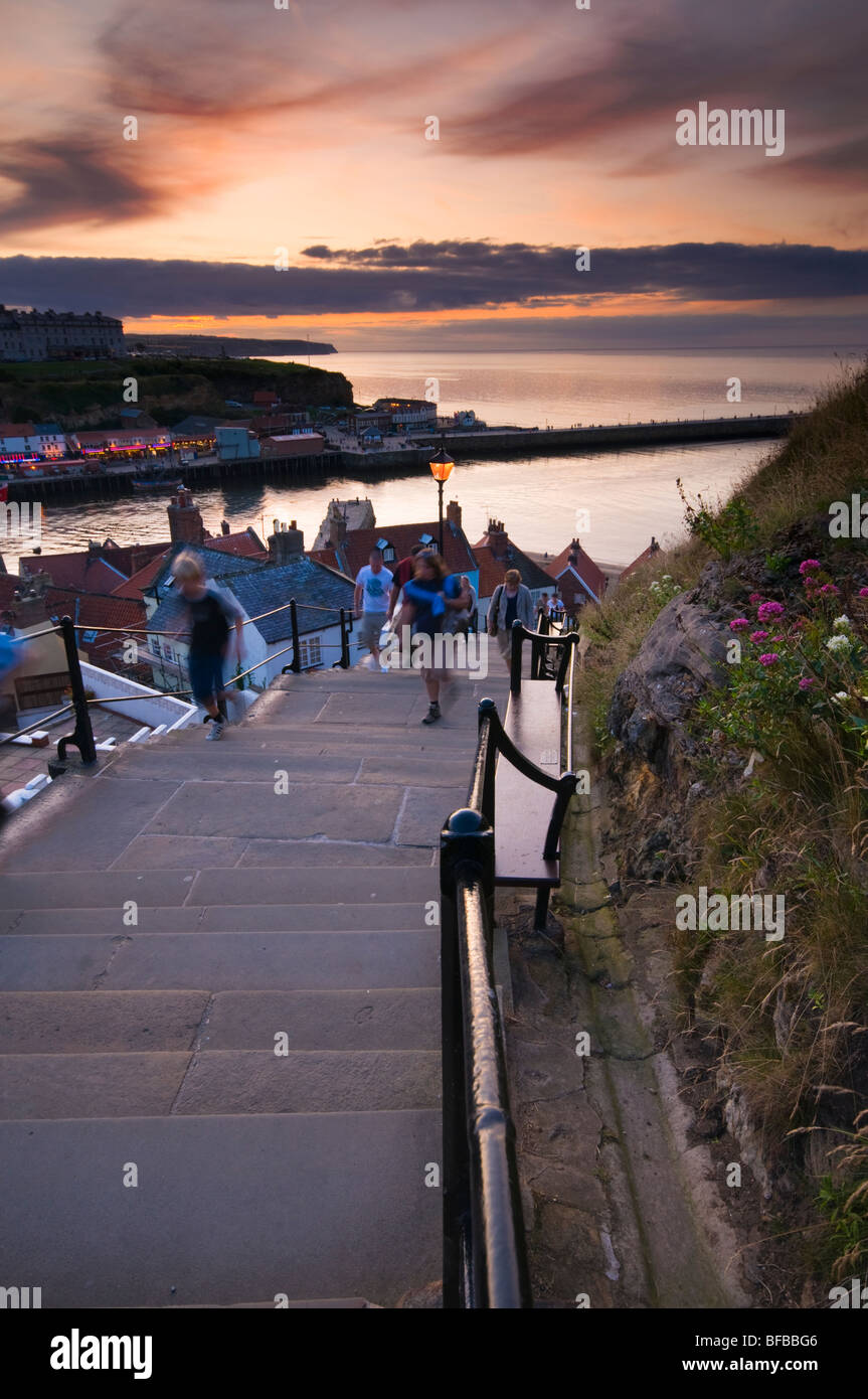 People going up the steps leading to St Mary's Church from Old Town of Whitby, North Yorkshire Stock Photo