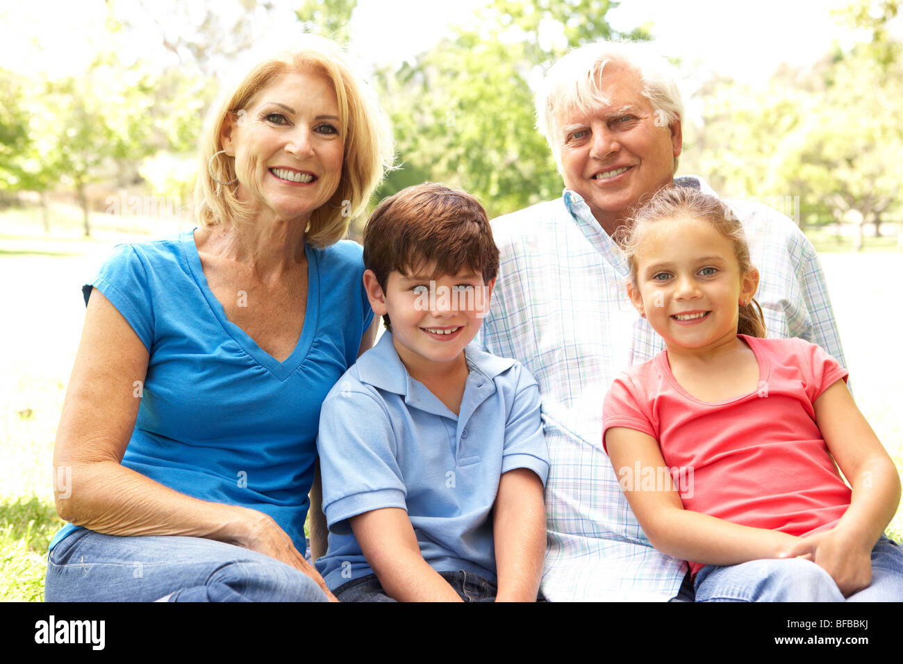 Grandparents And Grandchildren Enjoying Day In Park Stock Photo