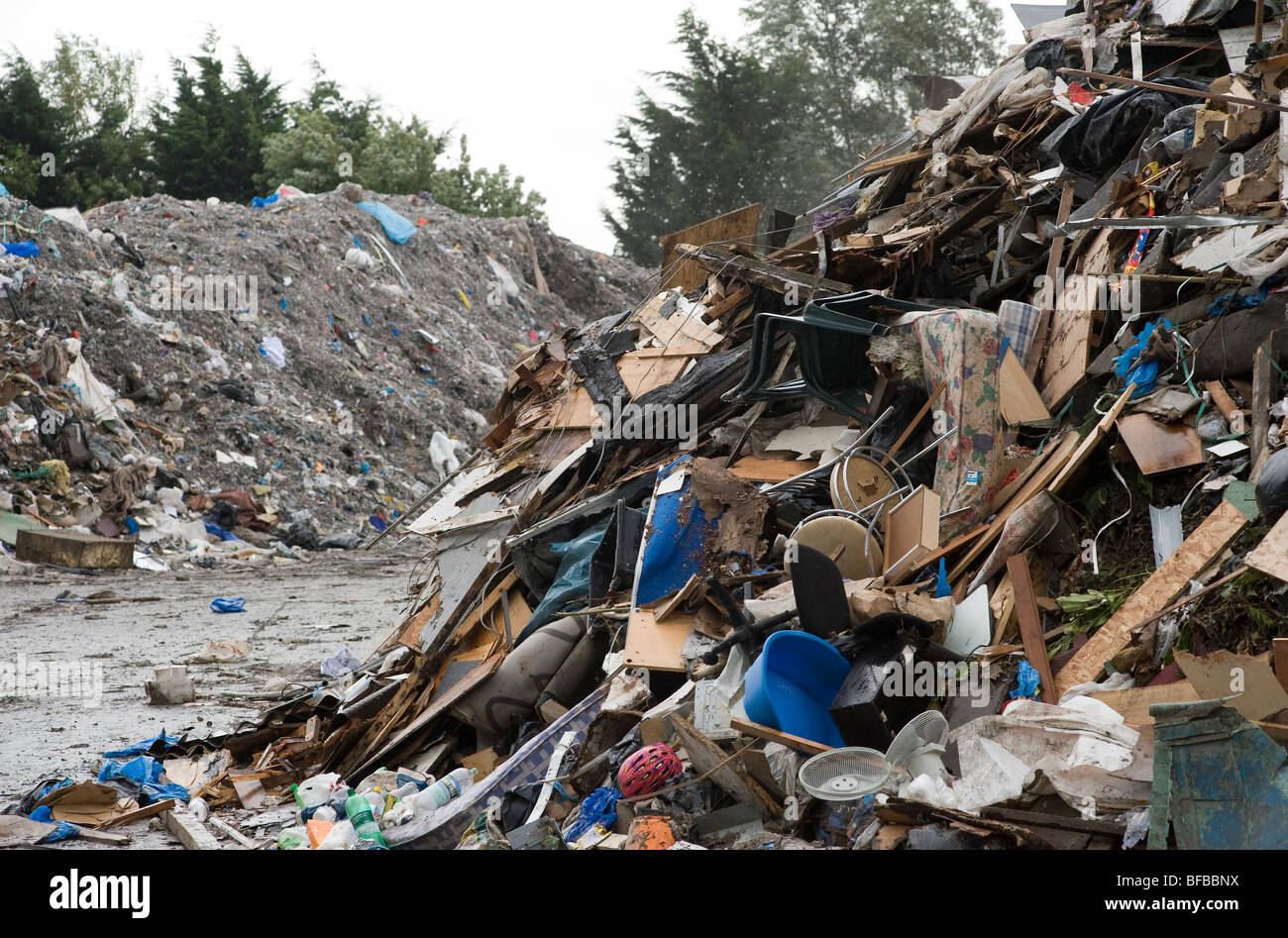 Rubbish piled high at a materials recovery facility waiting to be sorted. Stock Photo