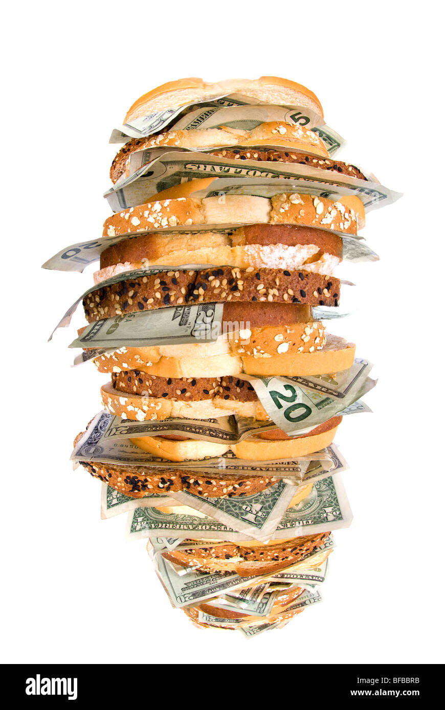 A giant, fresh money sandwich with multiple types of bread and cash denominations Stock Photo