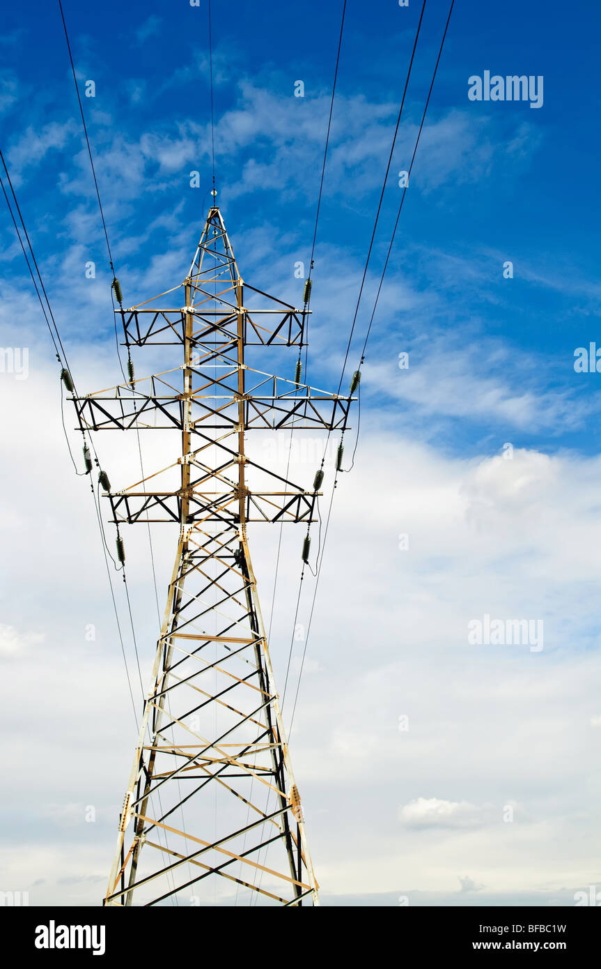 High voltage tower against a blue sky with clouds Stock Photo - Alamy