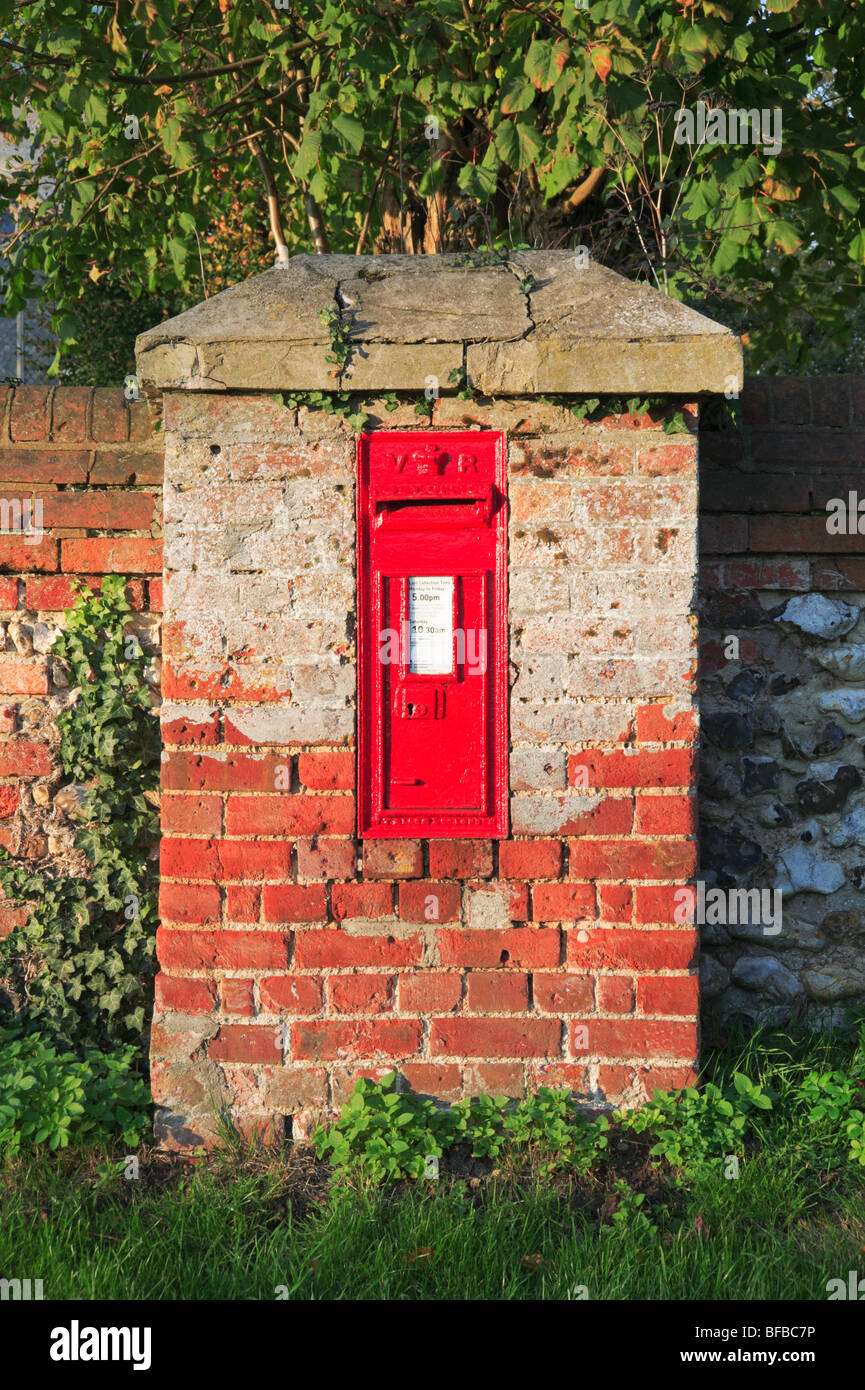 Early Victorian postbox located in a purpose built enclosure at Tunstead, Norfolk, United Kingdom. Stock Photo