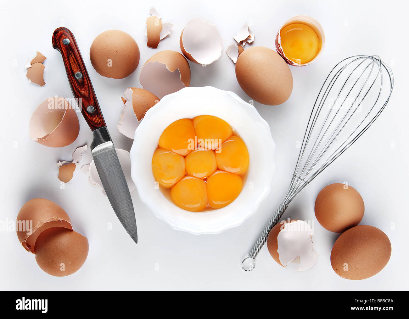 Chicken yelk in white plate with knife and shaker Stock Photo