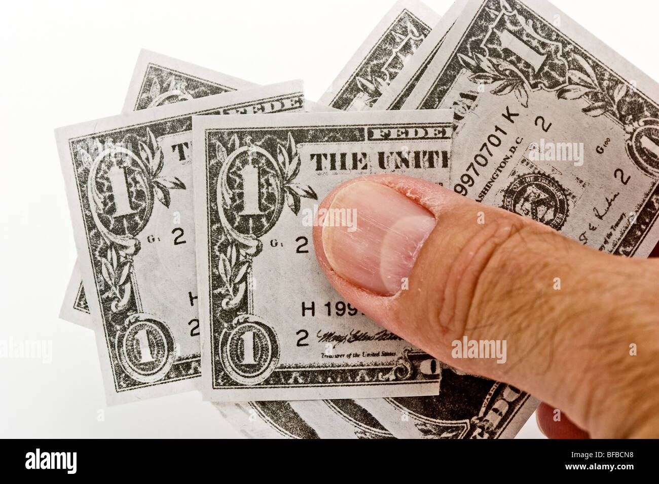 Hand holding a representation of torn US dollar bills Stock Photo Alamy