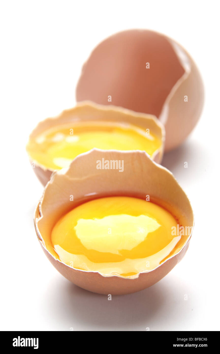 Brown egg shell and yelk on white Stock Photo