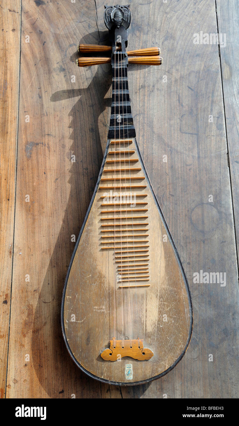 Antique Asian music instrument, pipa, hung in wall in a music