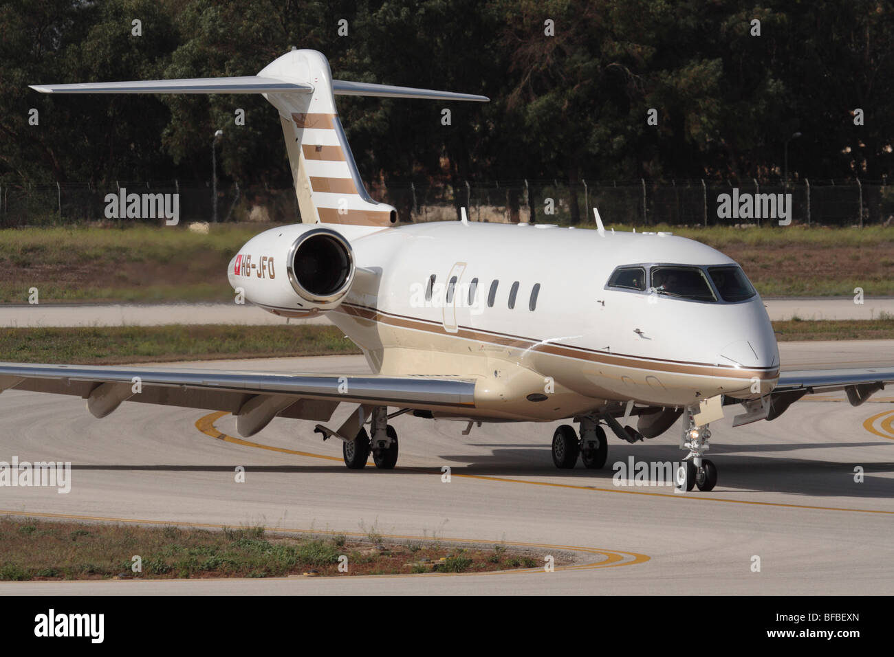 Bombardier Challenger 300 private jet taxiing on arrival at Malta International Airport. Close up view from in front. Stock Photo