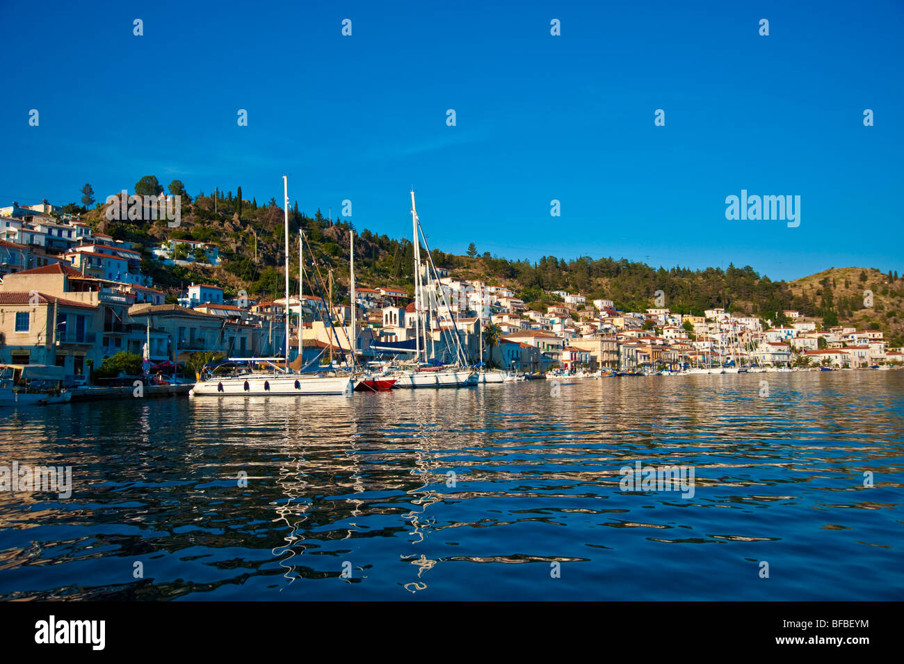 Sailing yachts anchoring in front of old town at Poros island, Greece