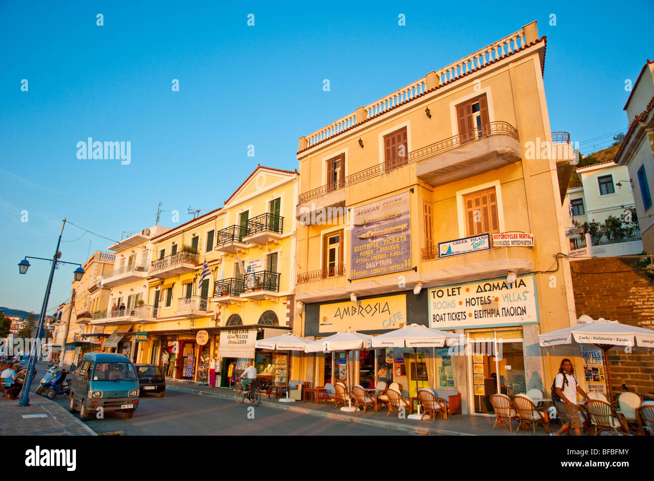 Bars and restaurants along main street at old town of Poros, Greece Stock Photo