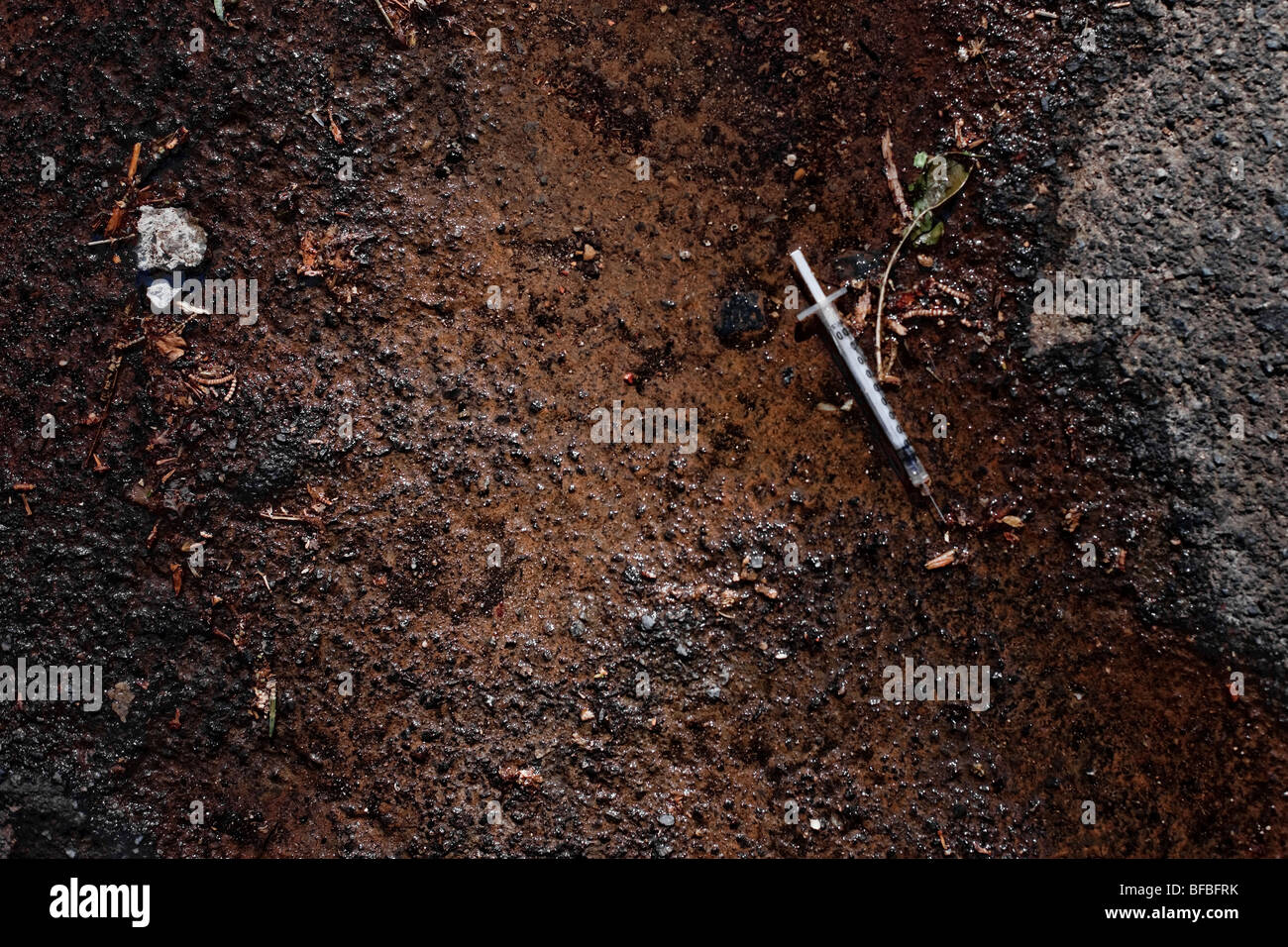 Discarded syringe on the side of the road next to a small public park in Surry Hills, Sydney, Australia Stock Photo