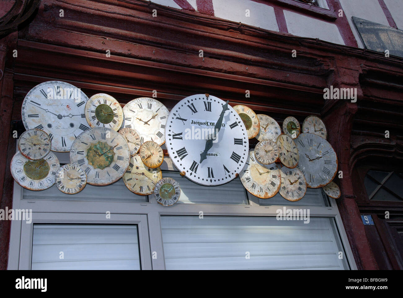 clocks faces above a door of clocks shop Vannes Morbihan Brittany