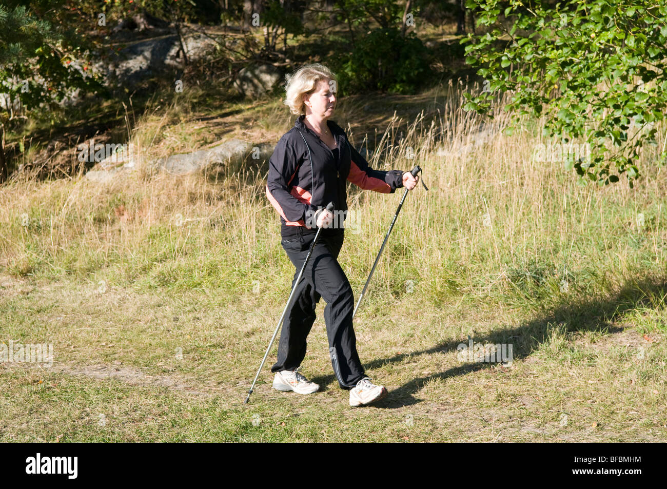Woman walking with sticks hi-res stock photography and images - Alamy