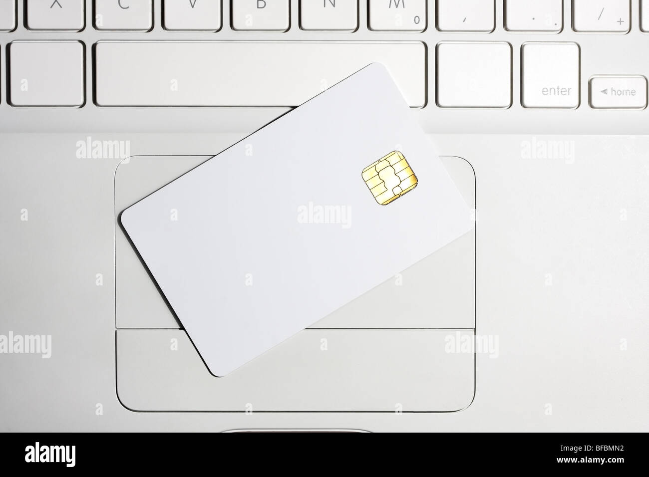 Modern security. White empty smart card close-up on laptop. Stock Photo