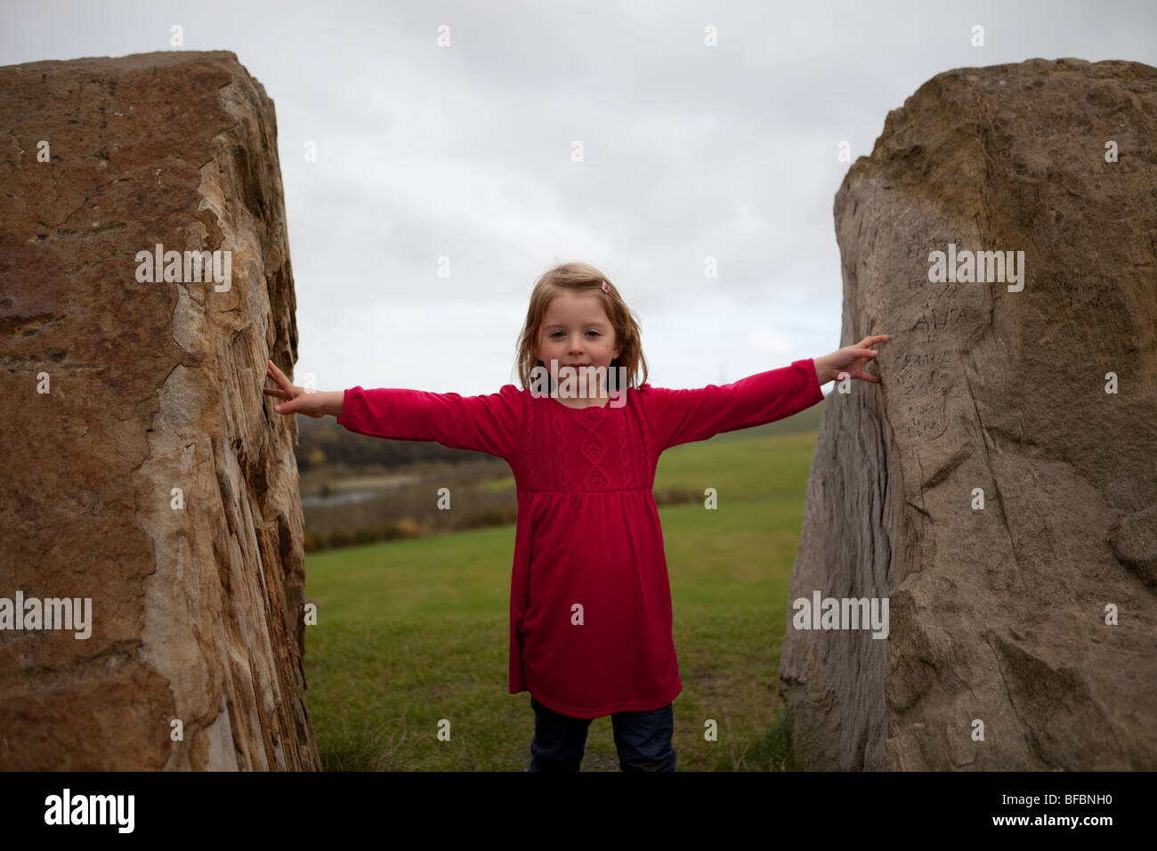 little girl between two stones Stock Photo - Alamy