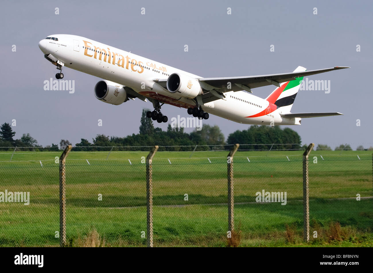 Boeing 777 operated by Emirates taking off from Birmingham Airport Stock Photo