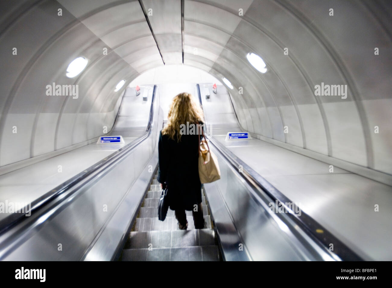 Woman on elevator, London underground. Stock Photo
