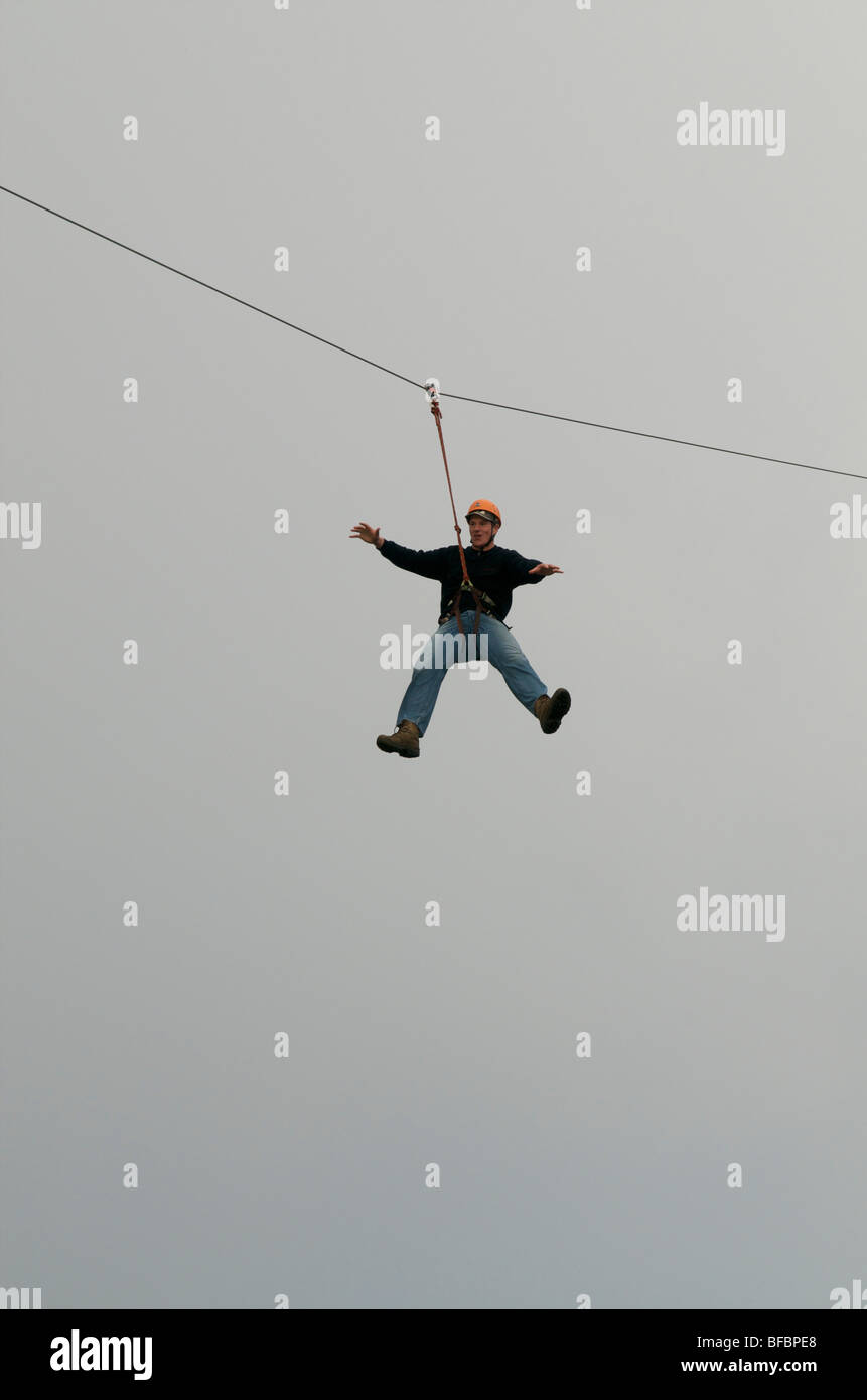 Man slides down on a zip wire Stock Photo