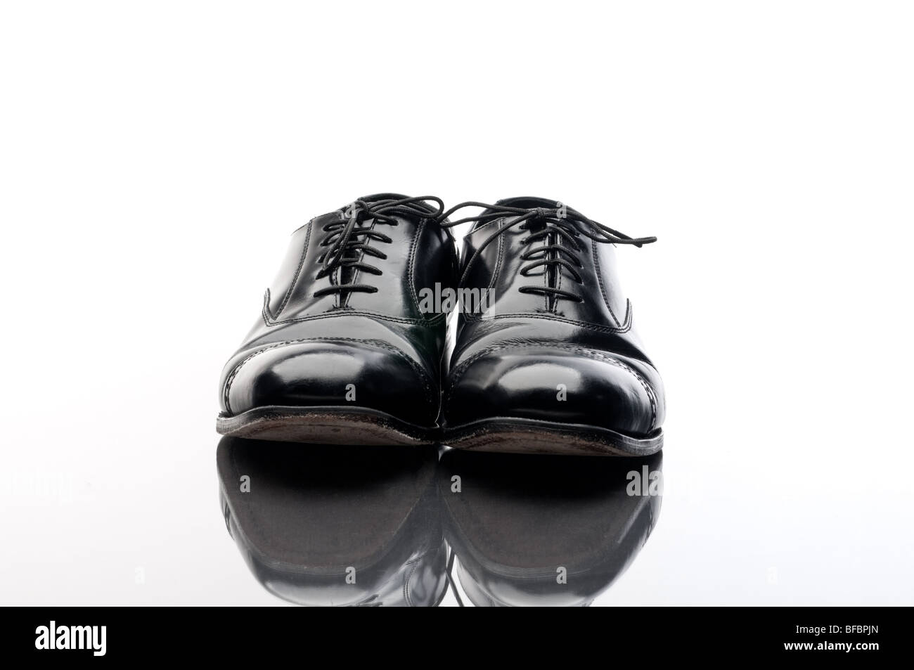 Black leather business shoes on a reflective surface Stock Photo