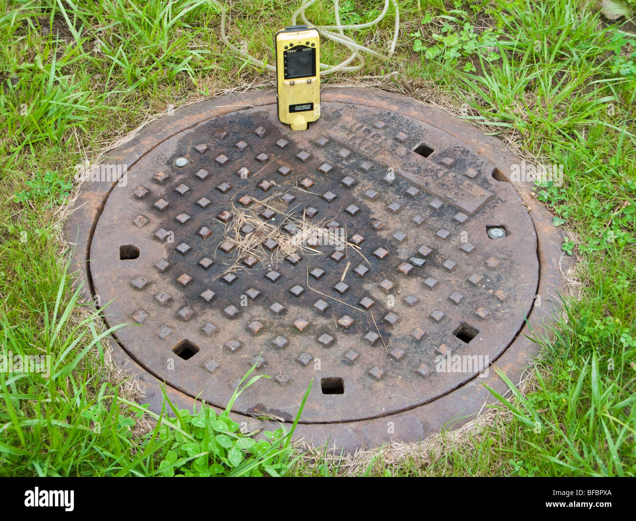 A portable multigas sensor checks for methane in a manhole before the
