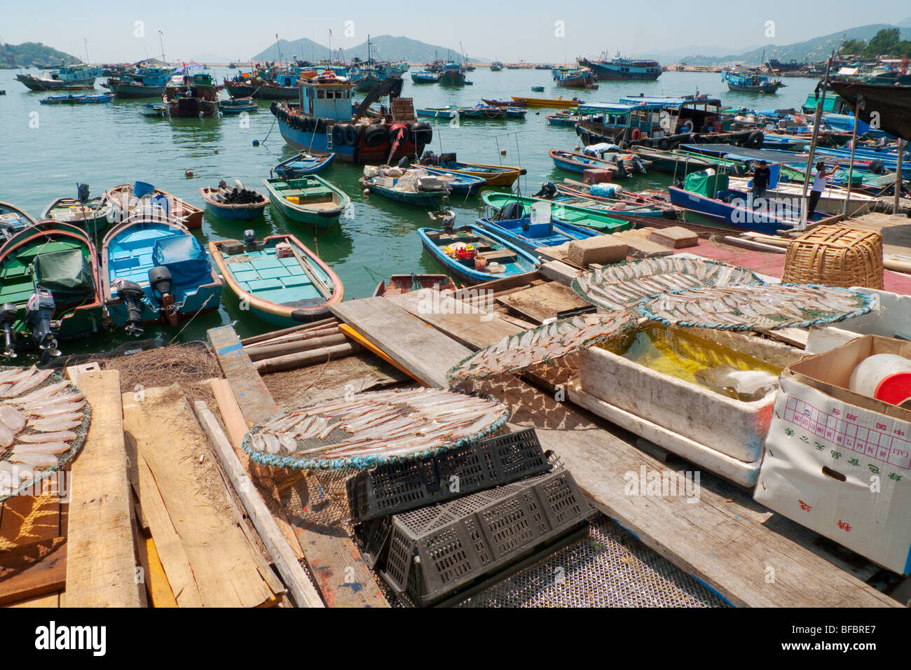 Fishing boats and drying filleted fish in the harbour at Cheung Chau, Hong Kong Stock Photo