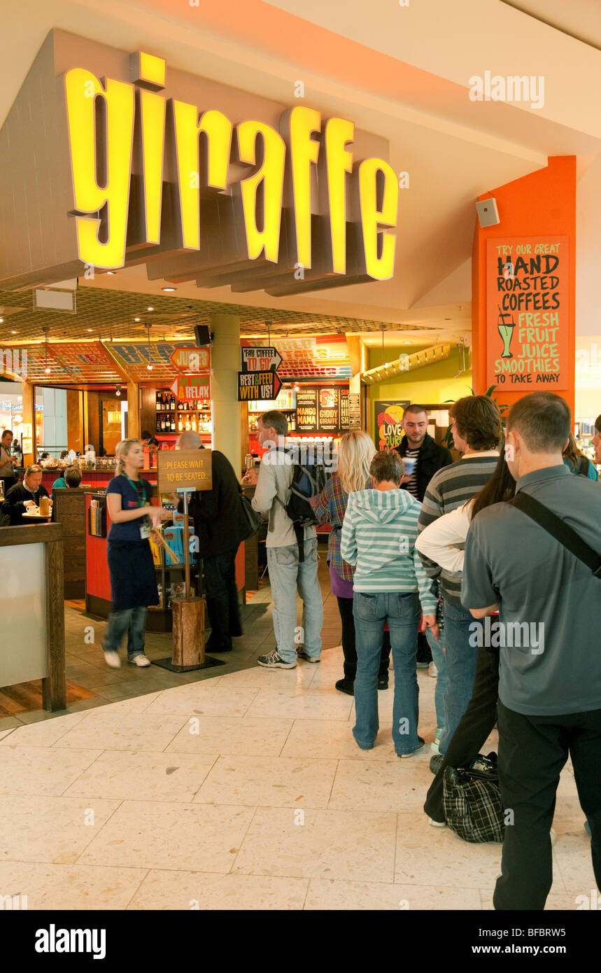 People queuing for the Giraffe restaurant, Departures, terminal One, Heathrow airport, London, UK Stock Photo
