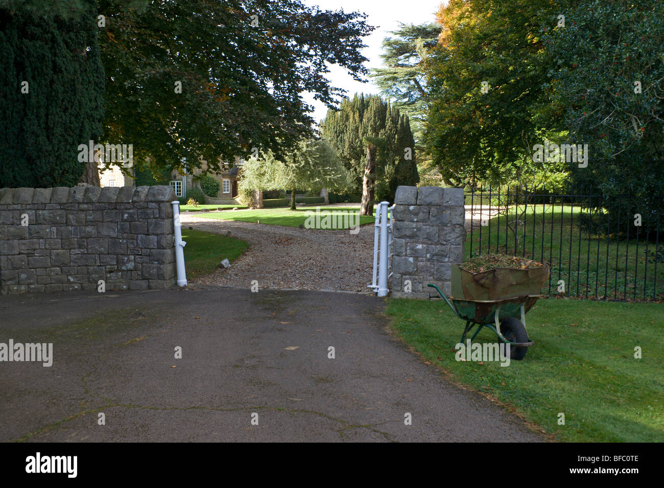 wheel barrow and gateway of large house near chepstow gloucestershire england Stock Photo Alamy