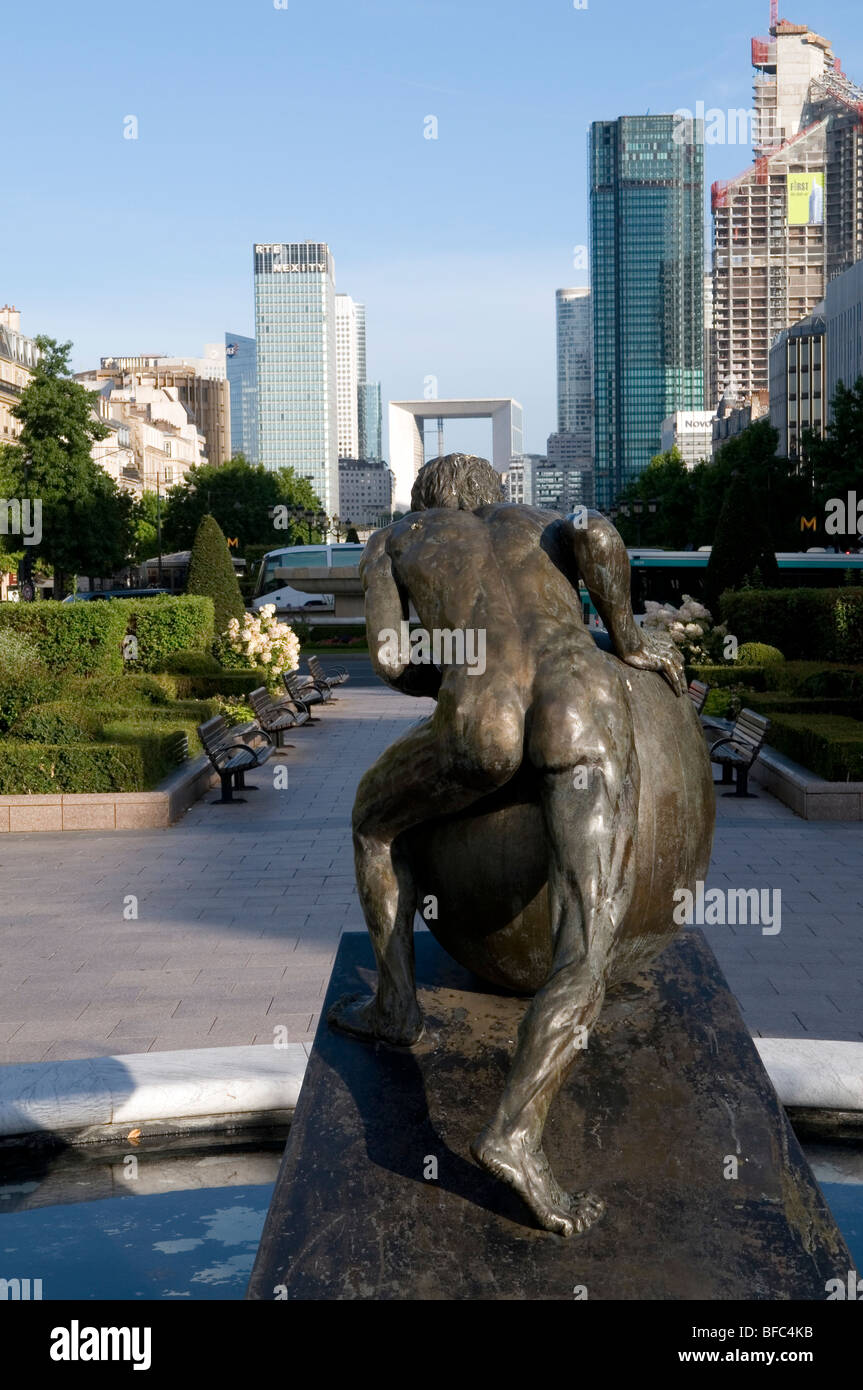 statue of a man pushing a big egg toward la Defense, Paris Stock Photo