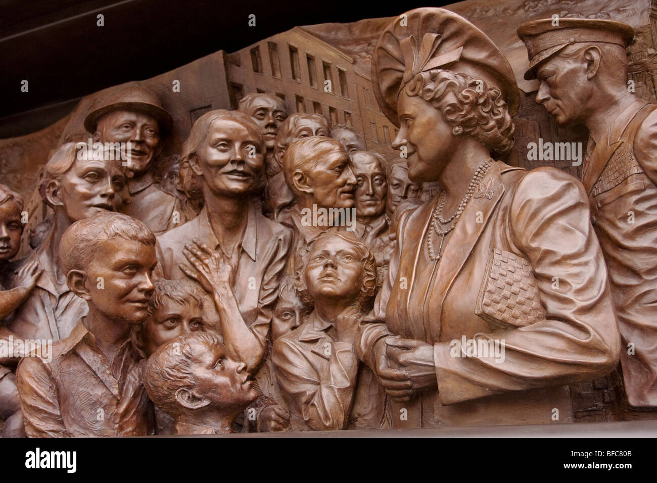 This relief shows the Queen Mother and King George V1 meeting Londoners during the Blitz of the second World War. Stock Photo